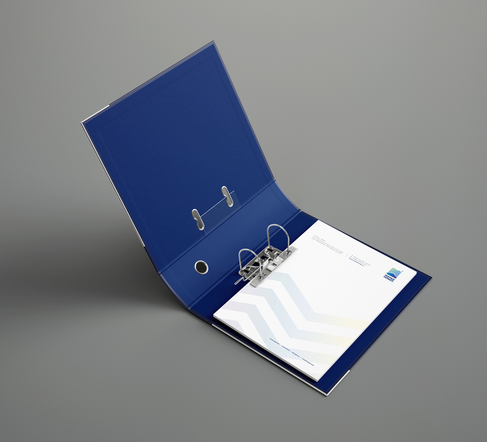 Open blue ring binder with Mayan Homes branded letterhead featuring geometric design and logo on a gray background